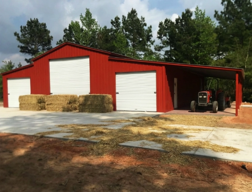 Red metal barn with horses and tractor